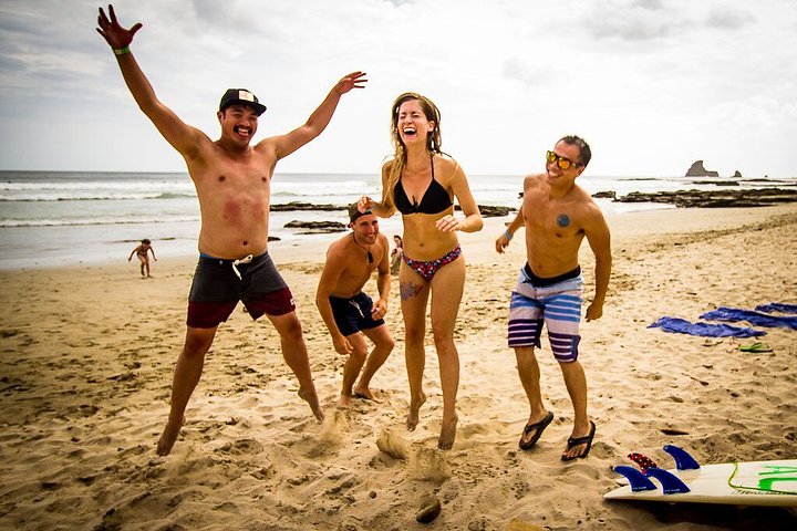people jumping and laughing on a beach in san juan nicaragu